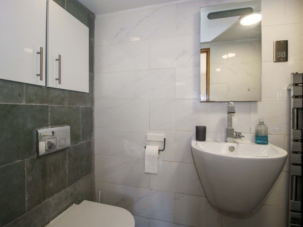 A bathroom with toilet and wash basin at The Lime Kiln Keepers Cottage in Ellesmere