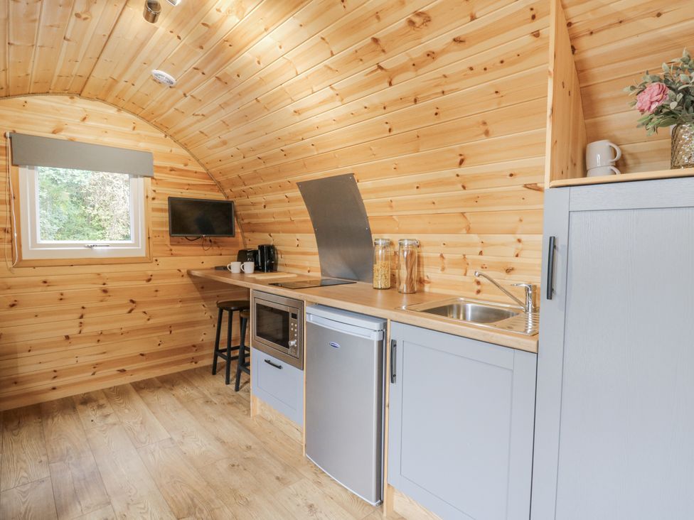 A kitchen with a refrigerator, sink, and microwave at Oak View in Rhayader