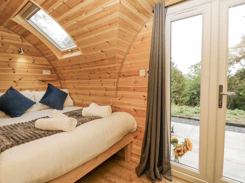 A bedroom with a bed and door to the outside at Oak View in Rhayader