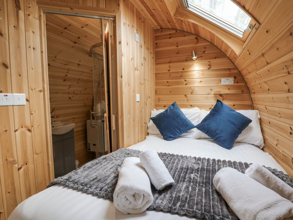 A bedroom with a bed and towels at Oak View in Rhayader