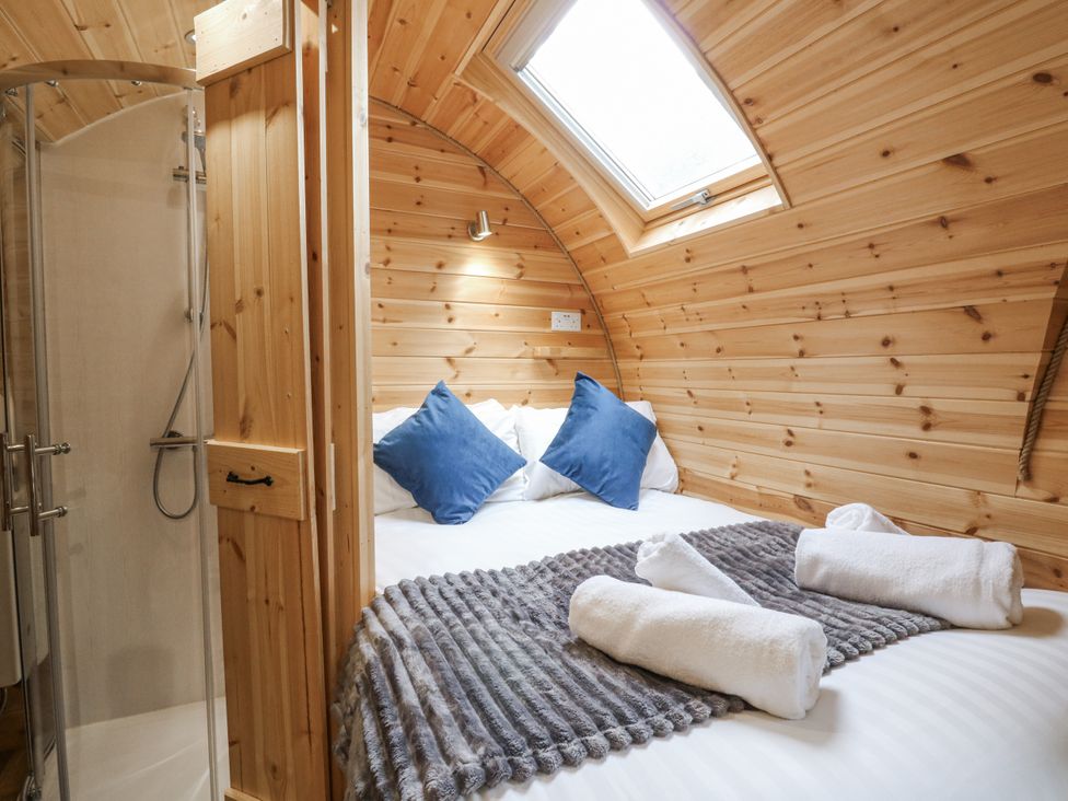 A bedroom with a bed, shower and towels at Oak View in Rhayader