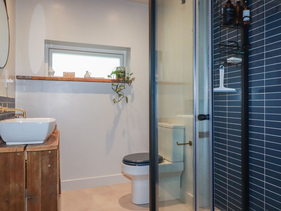 A bathroom with a shower and sink at Teach Tra West in Perranporth