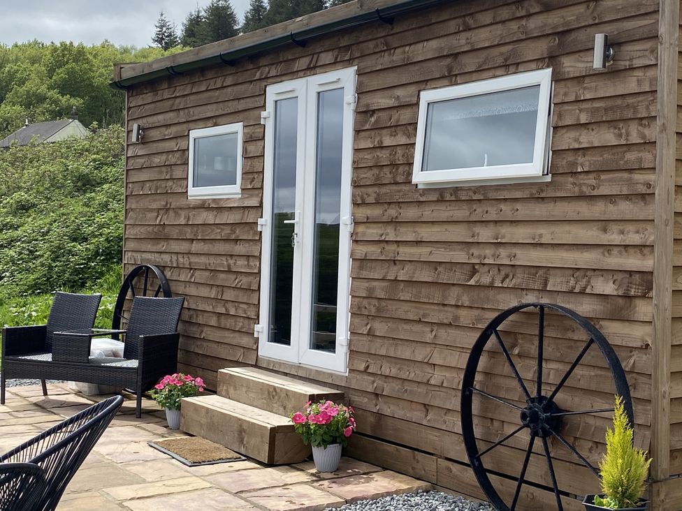 A wooden exterior with double doors and planters at Sychnant Farm Retreat Llanedi near Pontarddulais
