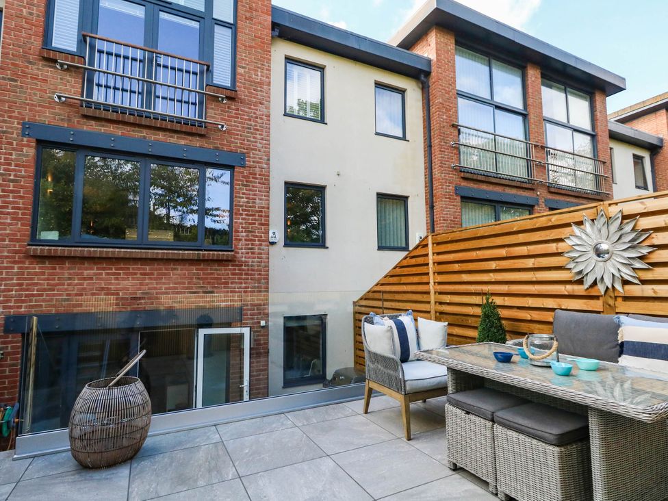 An outdoor area with furniture and a fence at Harbour Heights in Weymouth