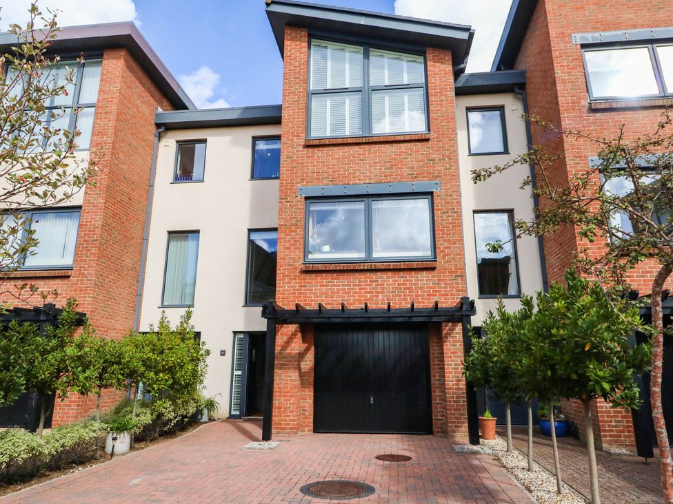 A townhouse with a garage and plants at Harbour Heights in Weymouth
