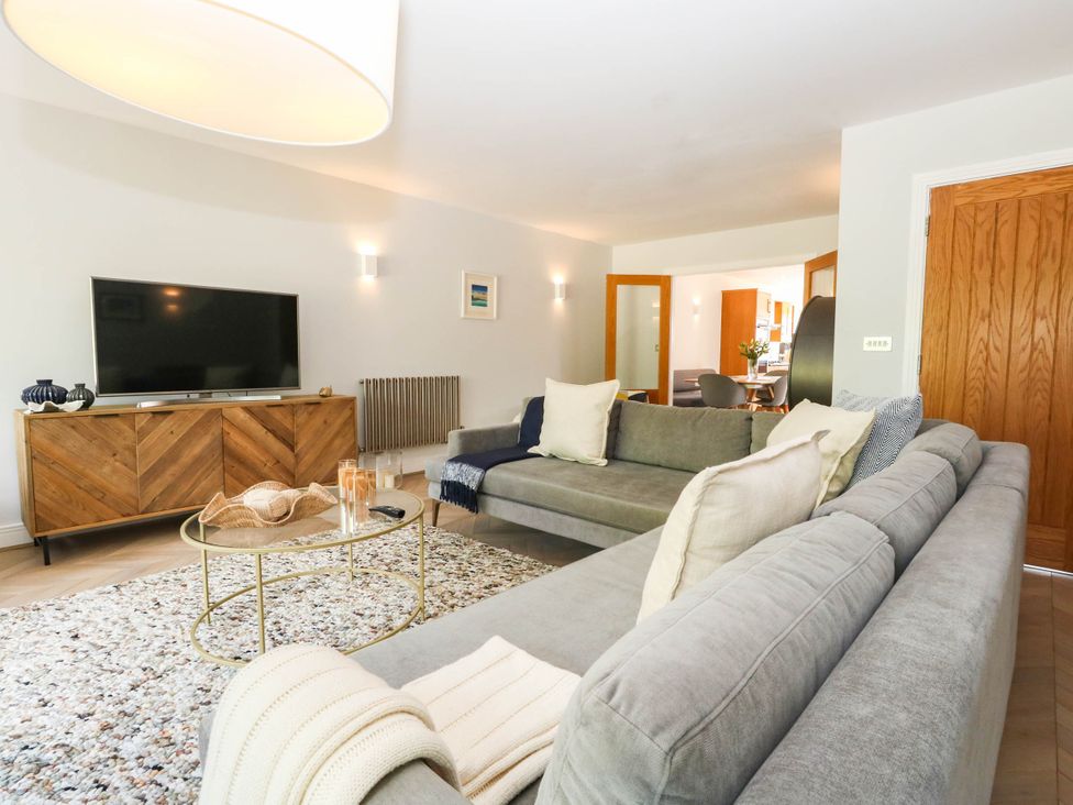 A living room with a sofa and television at Harbour Heights in Weymouth