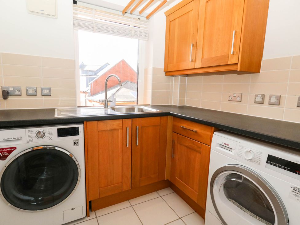 A laundry room with a washing machine and dryer at Harbour Heights in Weymouth