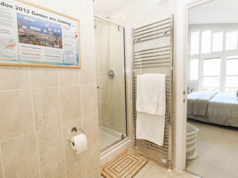 A bathroom with a shower and towel warmer at Harbour Heights in Weymouth