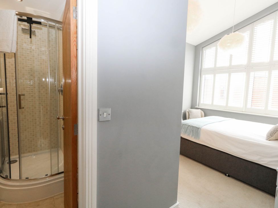 A bedroom with a shower and bed at Harbour Heights in Weymouth