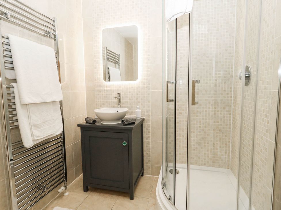 A bathroom with a shower and vanity unit at Harbour Heights in Weymouth