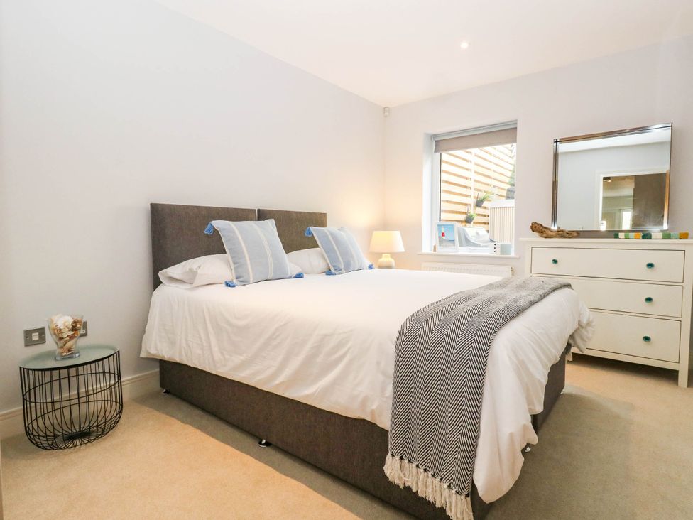 A bedroom with a bed and bedside table at Harbour Heights in Weymouth