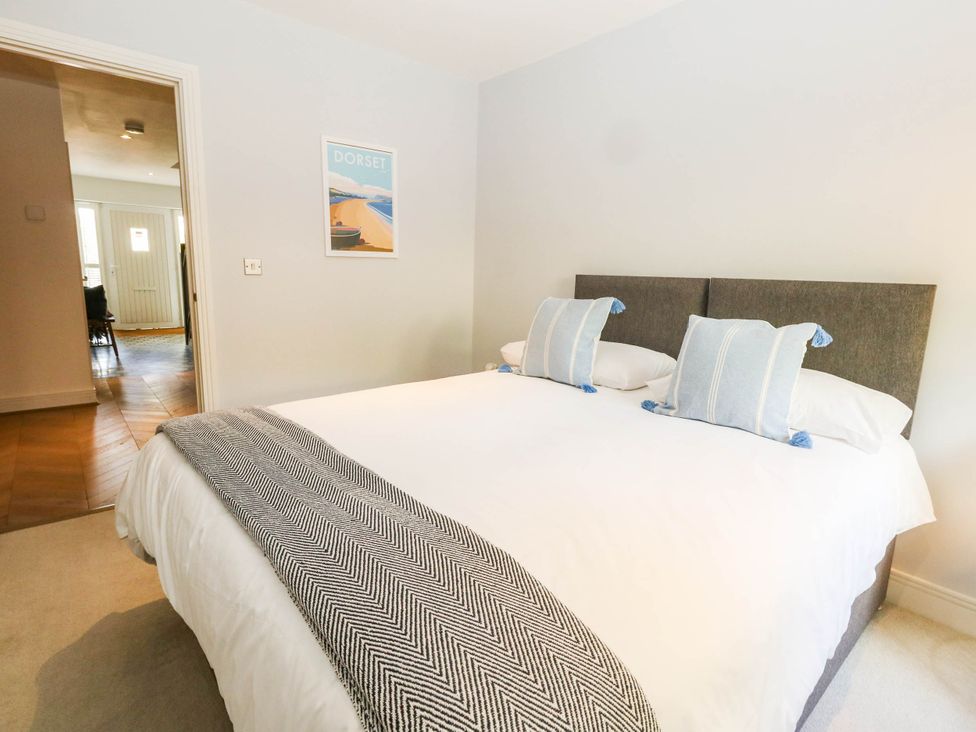 A bedroom with a bed and wall art at Harbour Heights in Weymouth