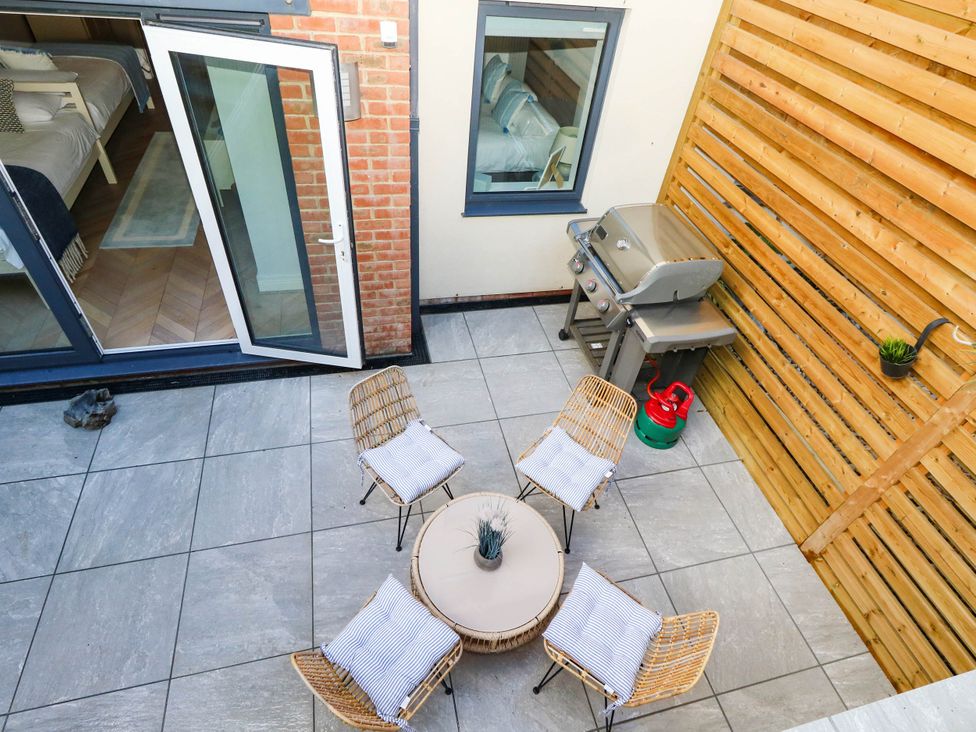 An outdoor space with seating and barbecue grill at Harbour Heights in Weymouth