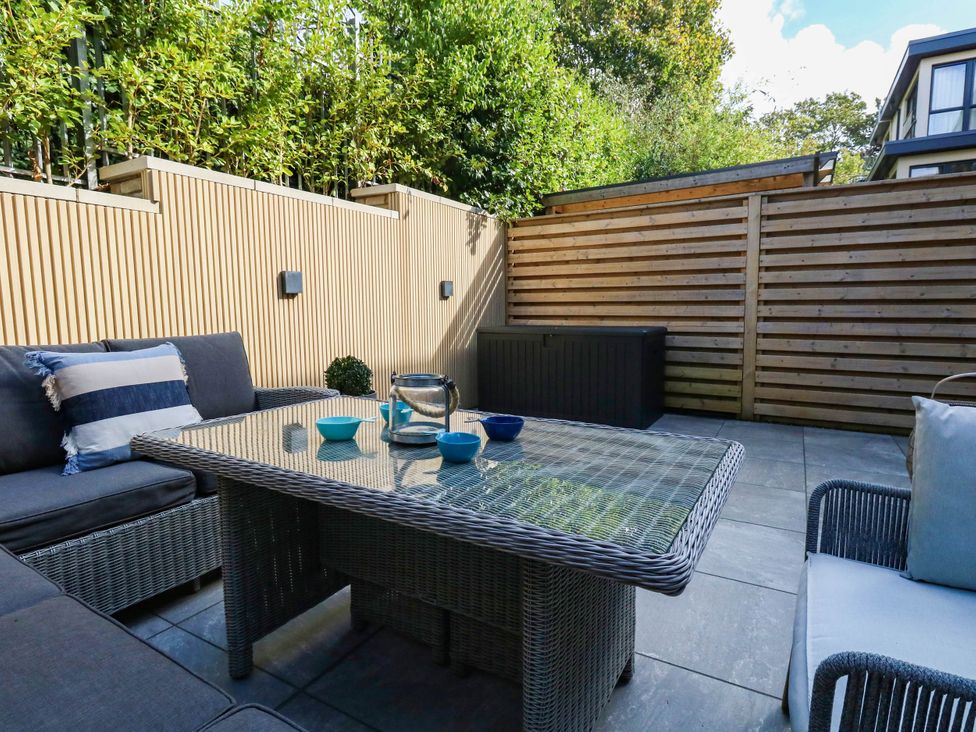 A patio area with seating and a table at Harbour Heights in Weymouth