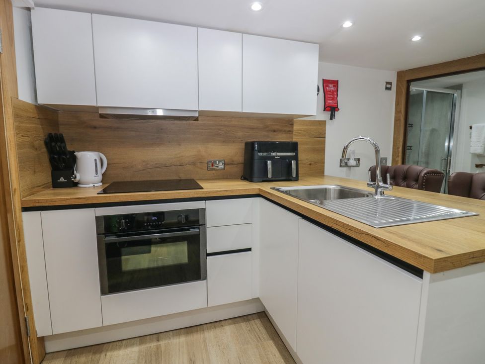 A kitchen with appliances and wood finish countertops at Park View Studio in Ambleside