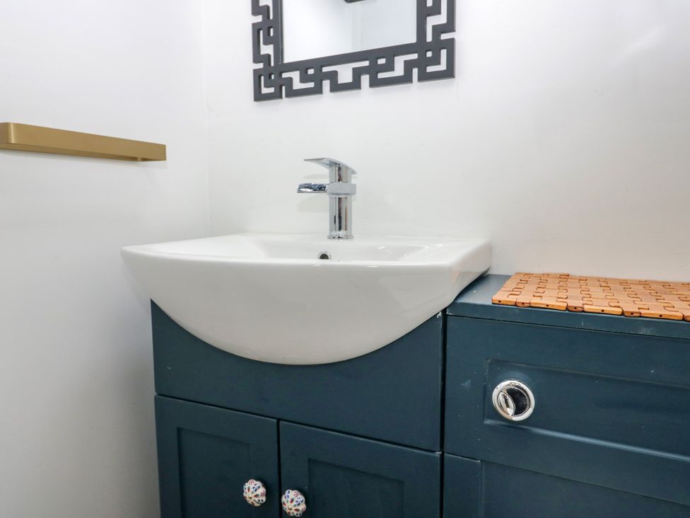 A sink with cabinet and mirror in a bathroom at Park View Studio Ambleside