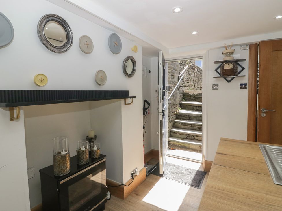 An entrance hall with decorative items and steps leading outside at Park View Studio in Ambleside
