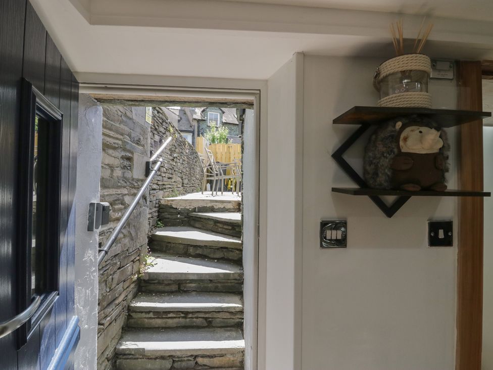 An entryway with steps and a shelf with a stuffed toy at Park View Studio Ambleside