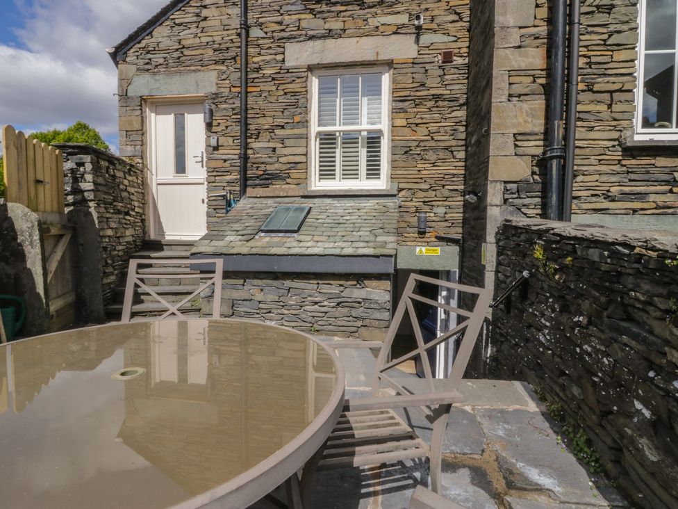 An outdoor seating area with a table and chairs at Park View Studio Ambleside