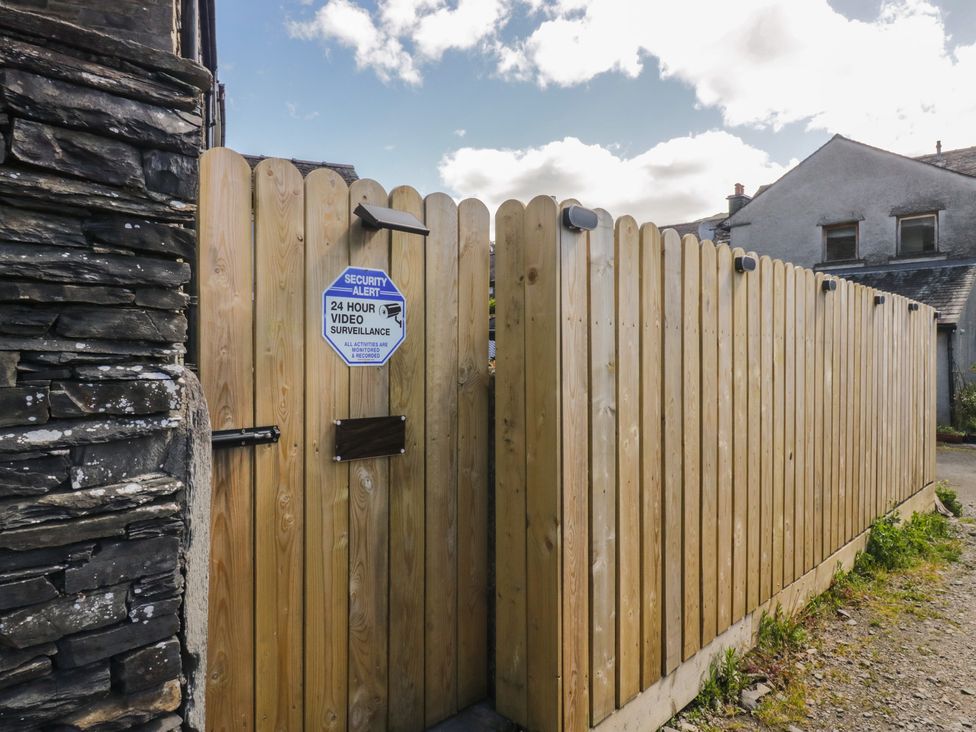 A wooden gate with a security sign at Park View Studio in Ambleside