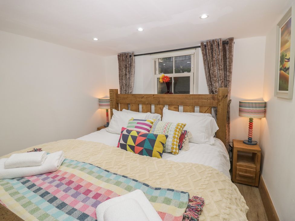 A bedroom with a bed and bedside tables at Park View Studio in Ambleside