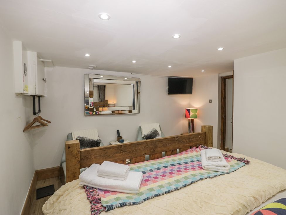 A bedroom with a bed and a television at Park View Studio in Ambleside