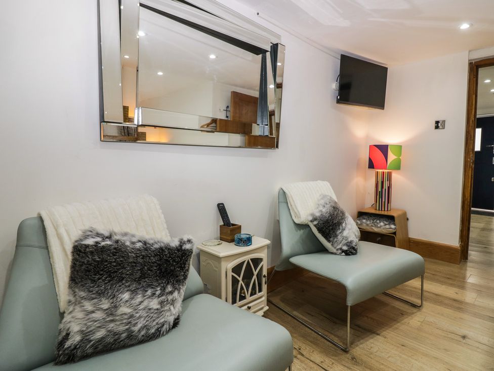 A living room with chairs and a lamp at Park View Studio in Ambleside