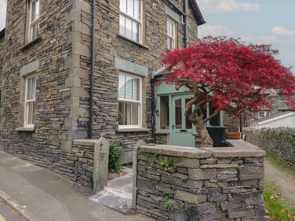 An outdoor view of a stone house with a tree at Park View in Ambleside
