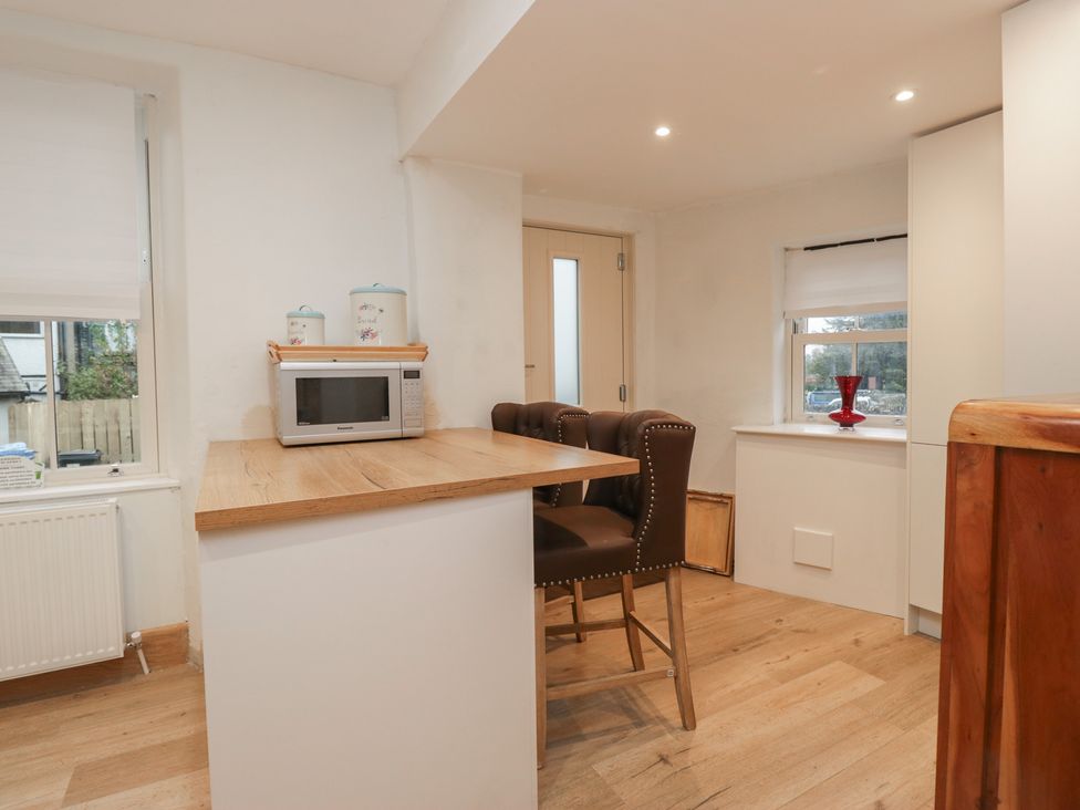 A kitchen with a microwave and seating at Park View in Ambleside