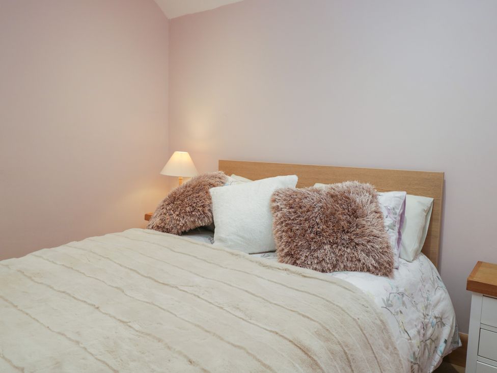 A bedroom with a bed and pillows at Park View in Ambleside