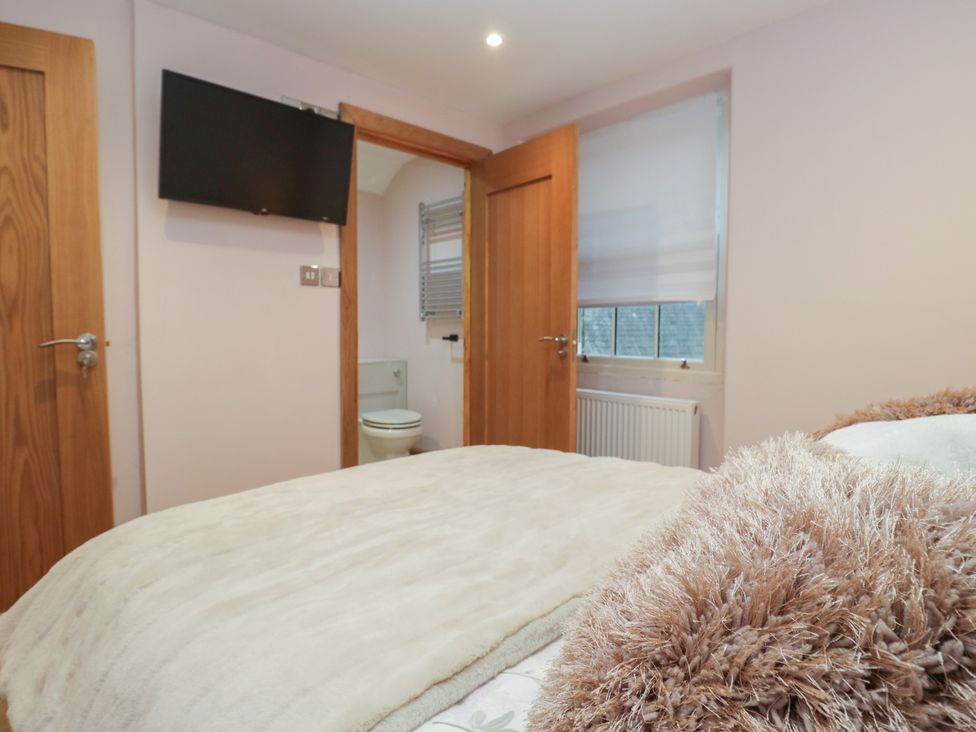A bedroom with a bed and television at Park View in Ambleside