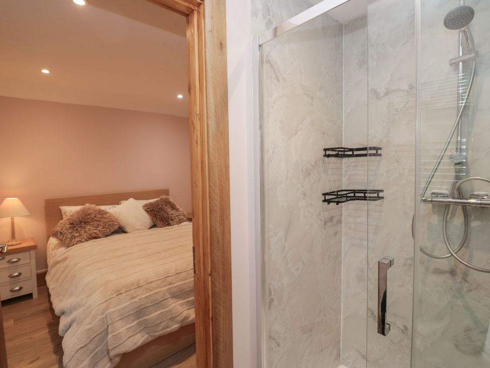 A bedroom with a bed and shower at Park View in Ambleside