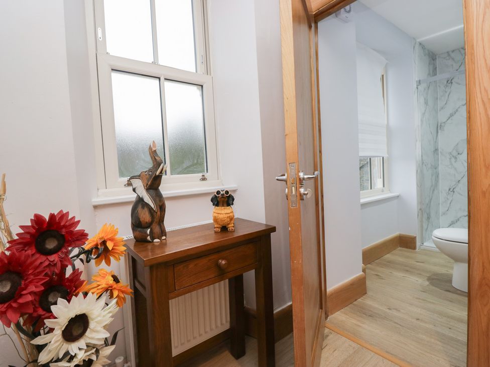 A bathroom with a toilet and decorative items at Park View in Ambleside
