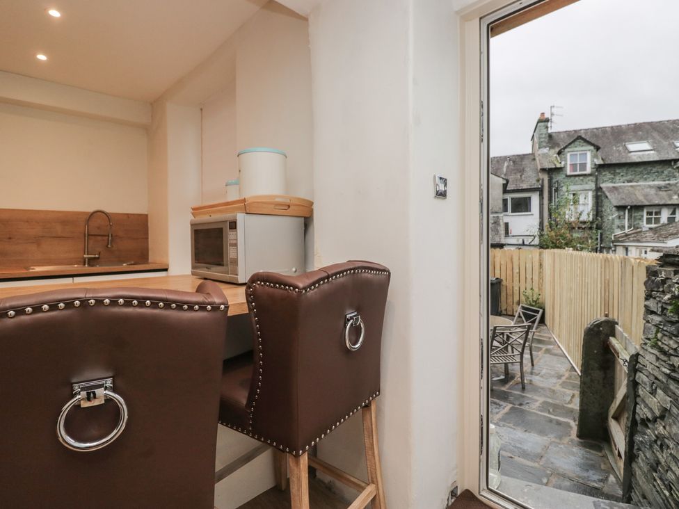 A kitchen with bar stools and a microwave at Park View in Ambleside