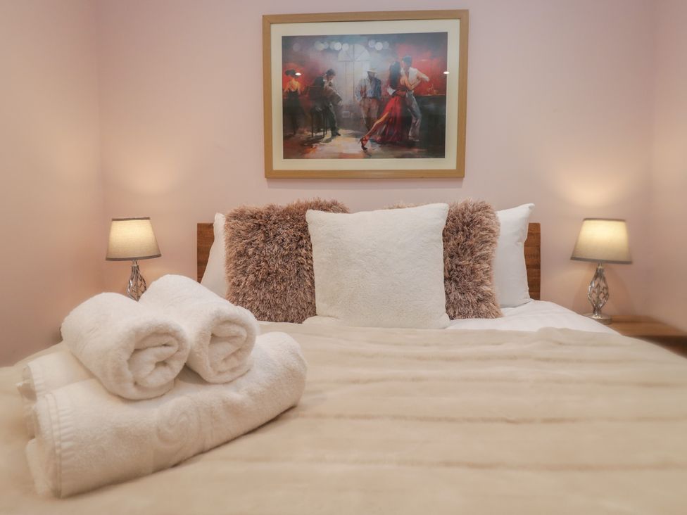 A bedroom with a bed and pillows at Park View in Ambleside