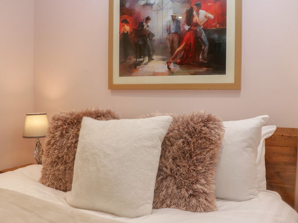 A bedroom with pillows and a painting at Park View in Ambleside