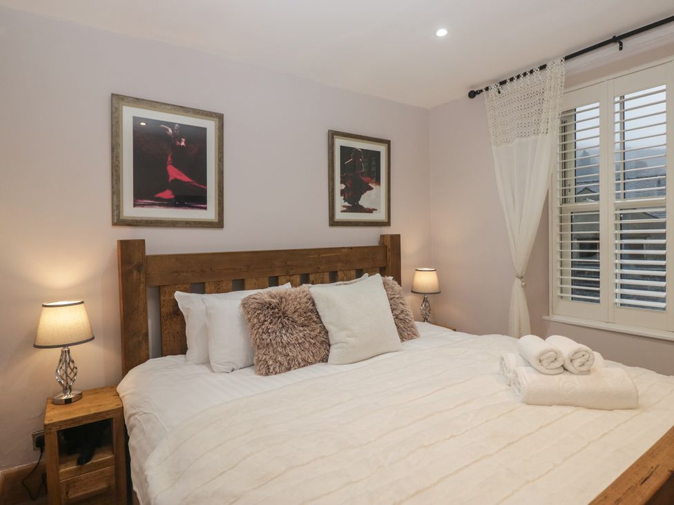A bedroom with a bed and bedside tables at Park View in Ambleside
