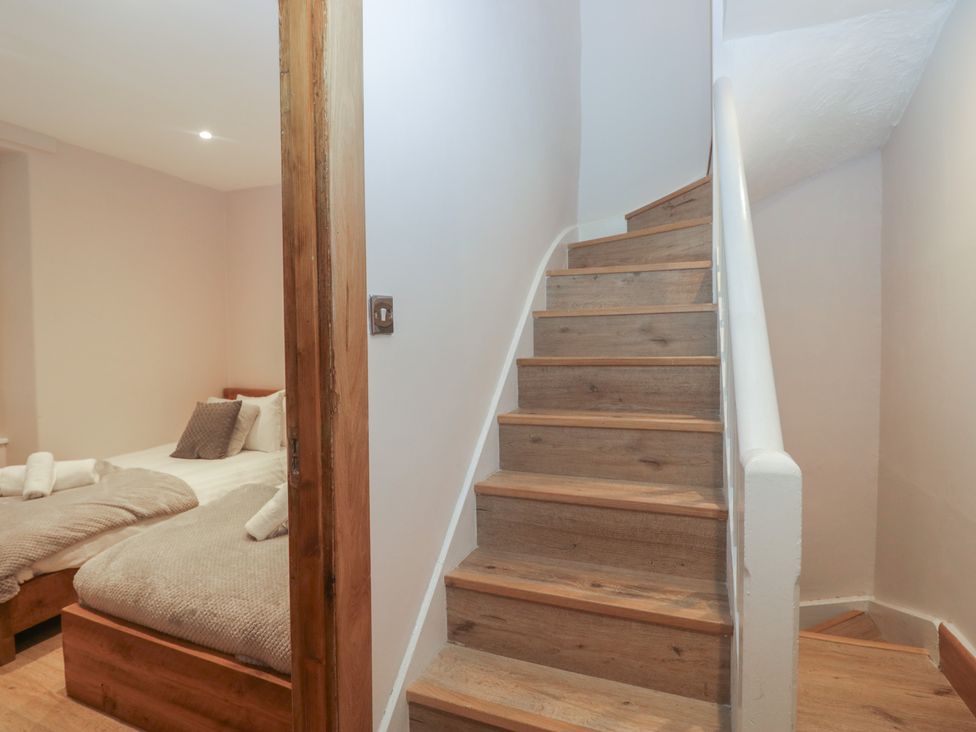 A staircase and a bedroom with bed and bedding at Park View in Ambleside