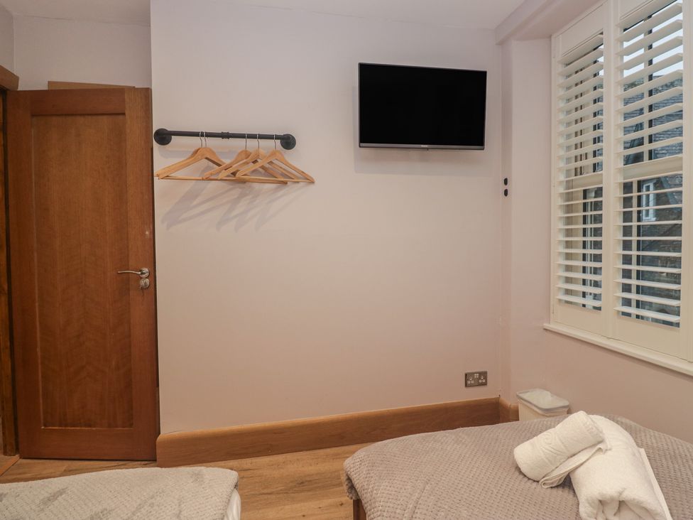A bedroom with a television and hangers at Park View in Ambleside