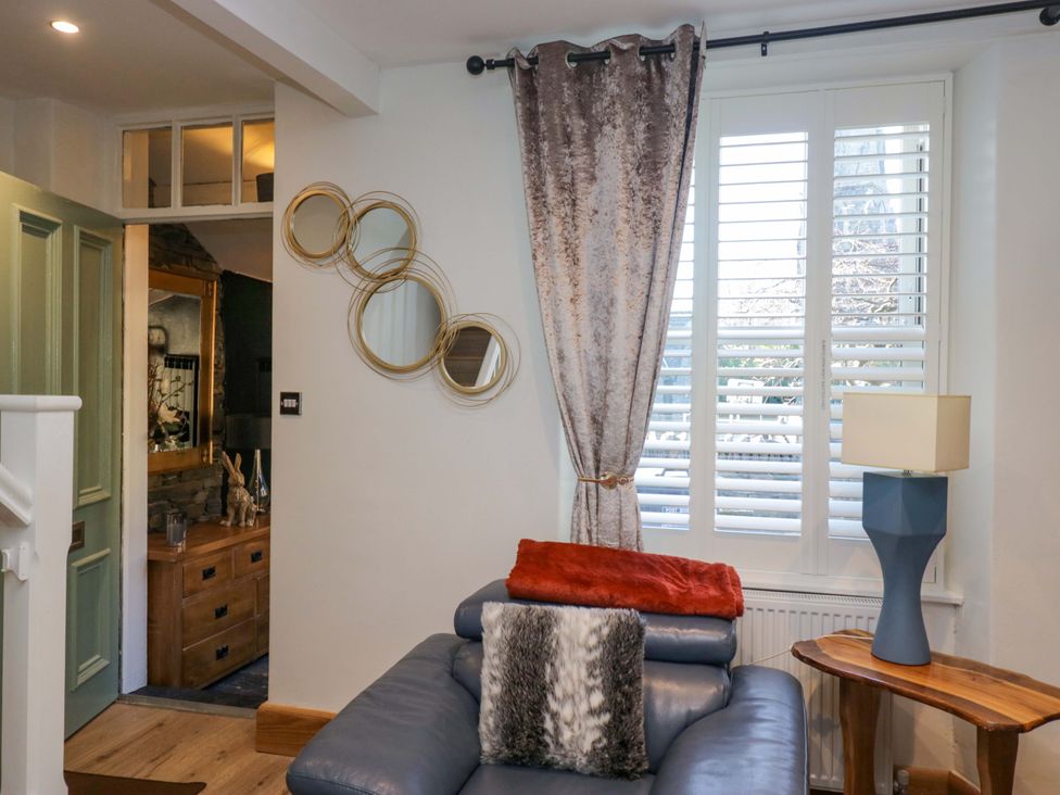 A living room with a sofa and curtain at Park View in Ambleside