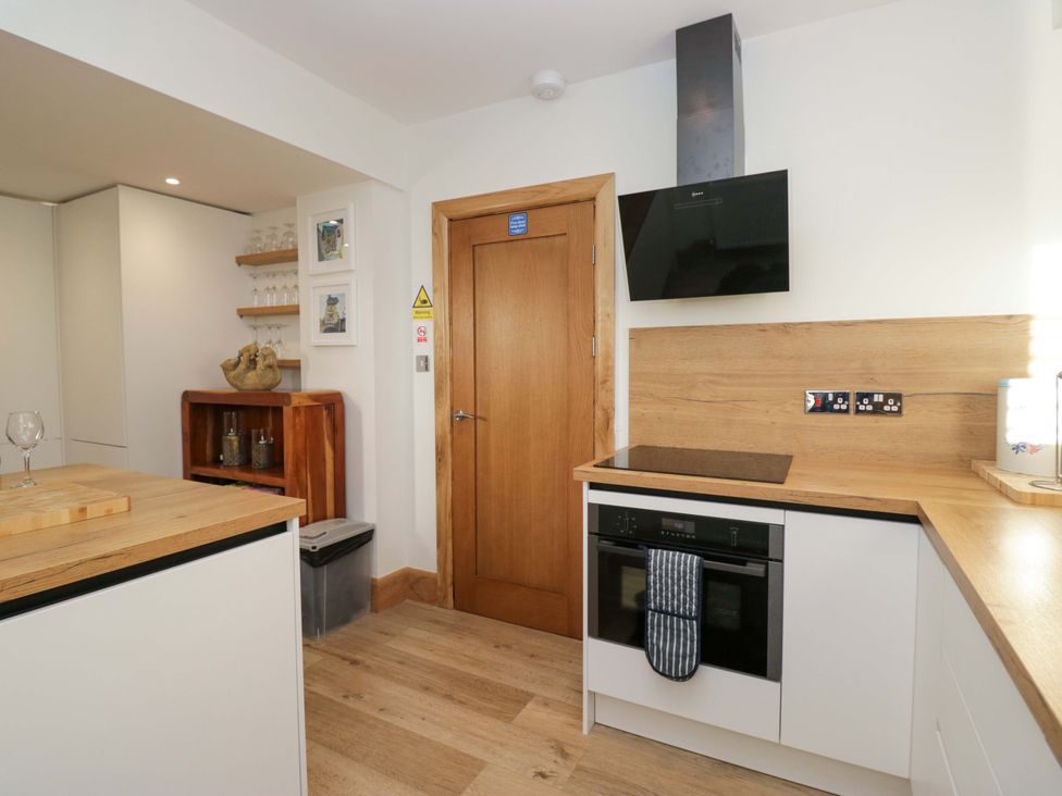 A kitchen with appliances and wooden countertop at Park View in Ambleside