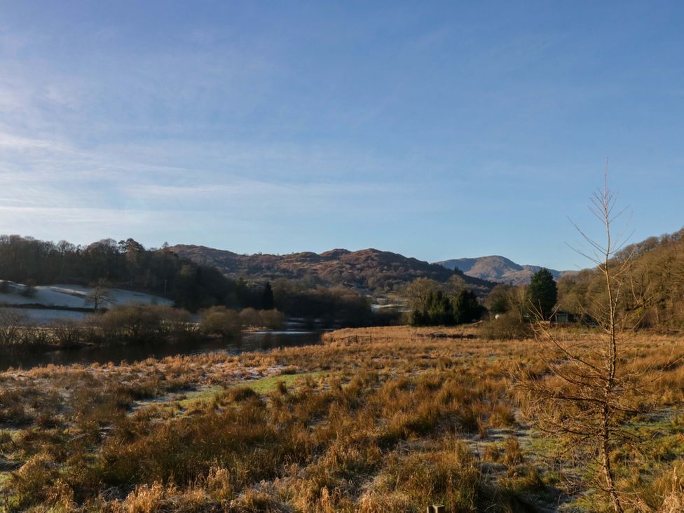 A landscape with grass, river and hills at Park View Ambleside