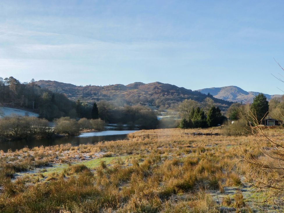 A view of a lake surrounded by trees and mountains at Park View in Ambleside
