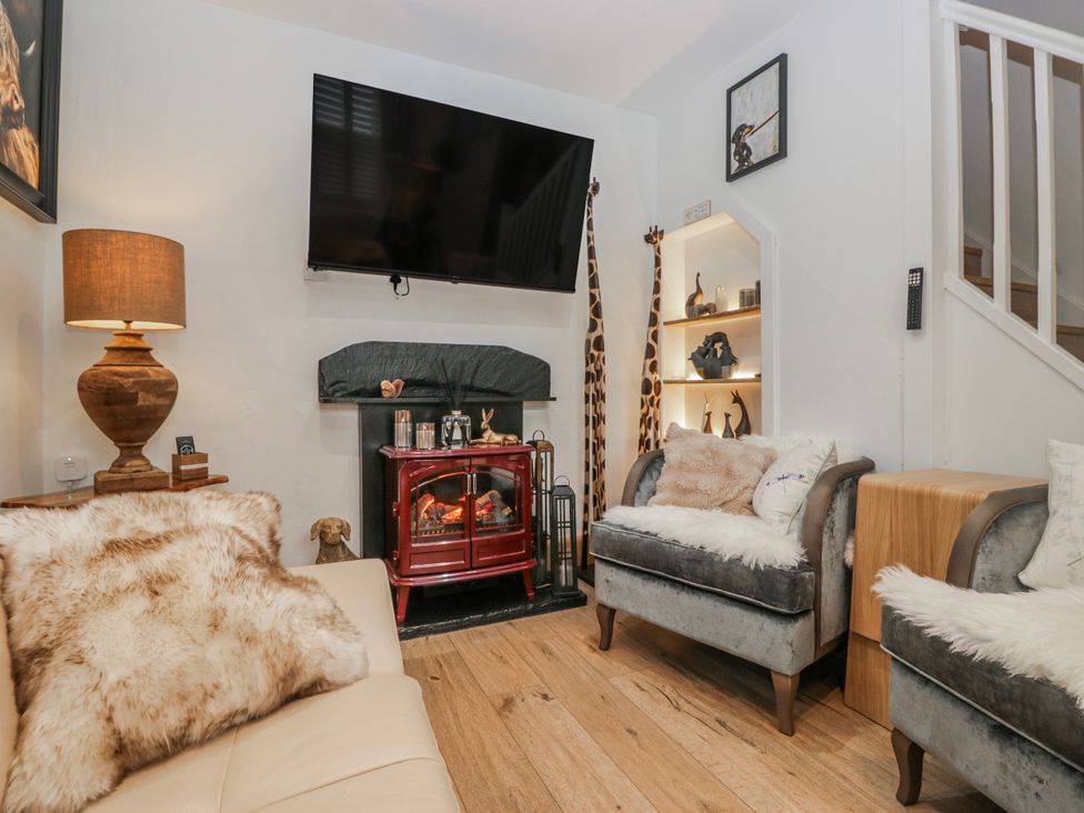 A living room with a fireplace and television at Park View in Ambleside