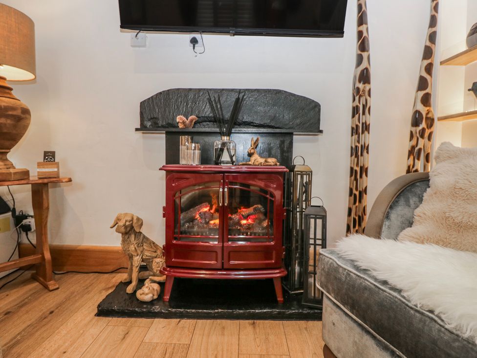 A living room with fireplace and television at Park View in Ambleside
