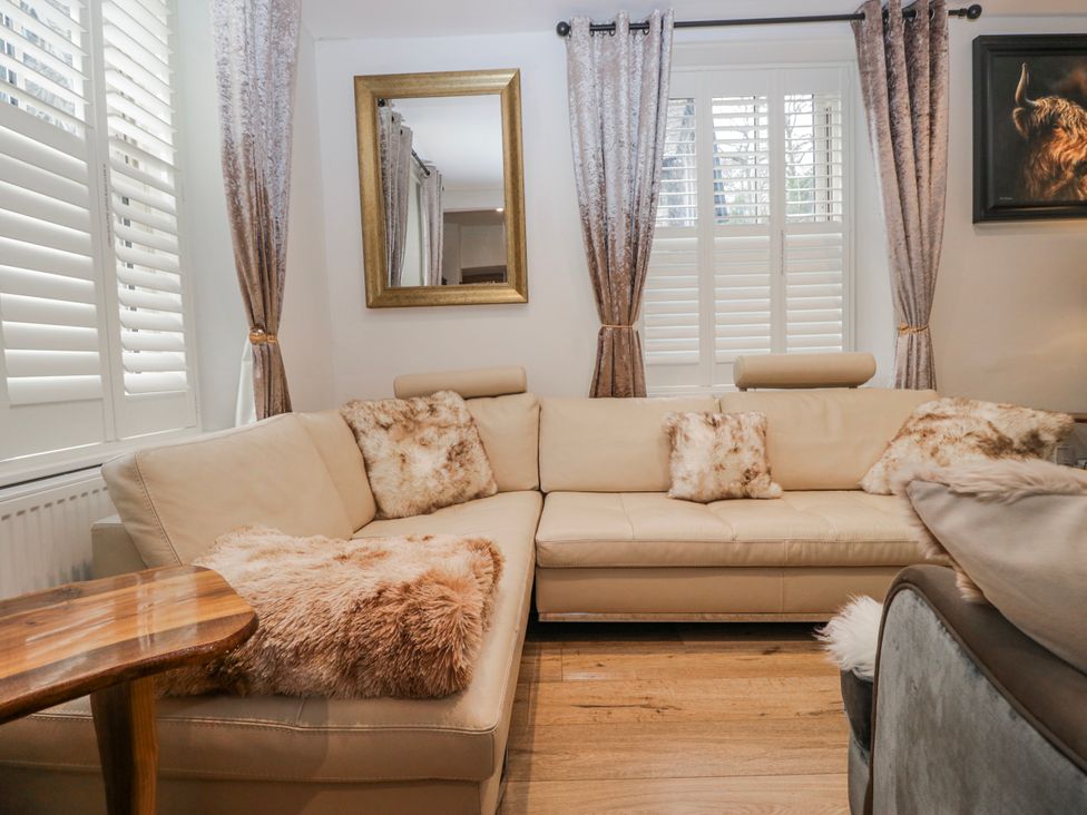 A living room with a sofa and curtains at Park View in Ambleside