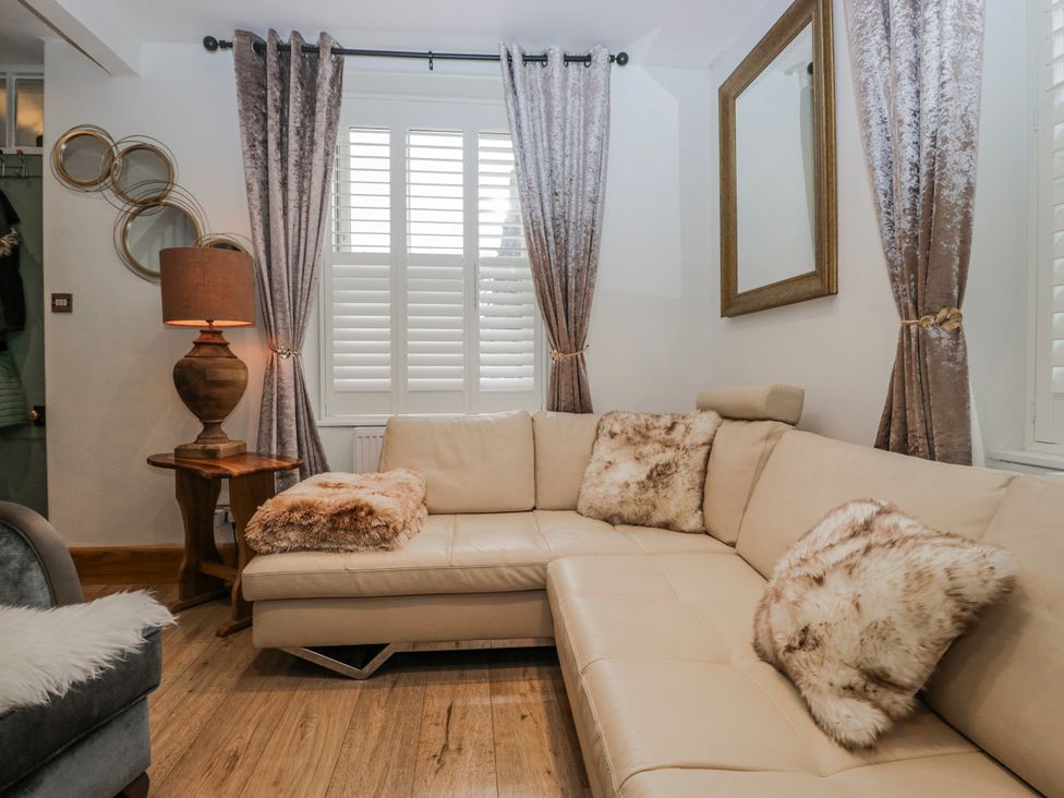 A living room with a sofa and lamp at Park View in Ambleside