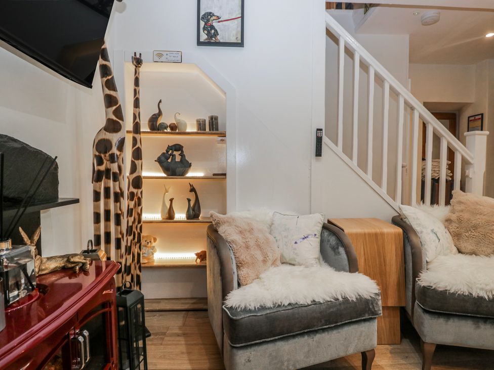 A living room with sofas and decorative shelves at Park View in Ambleside