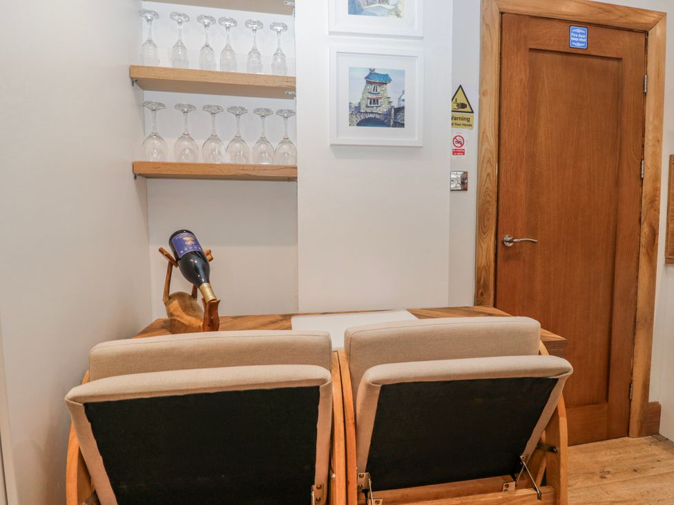 A dining room with wine glasses and a table at Park View Ambleside