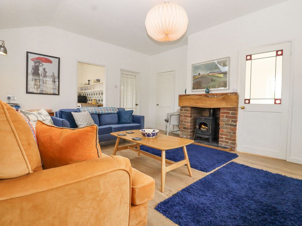 A living room with sofas and a fireplace at Greengates in Rye